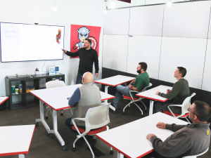 A group conducts a meeting in a training room.