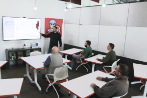 A team meeting is held in a conference room at DSTATION.
